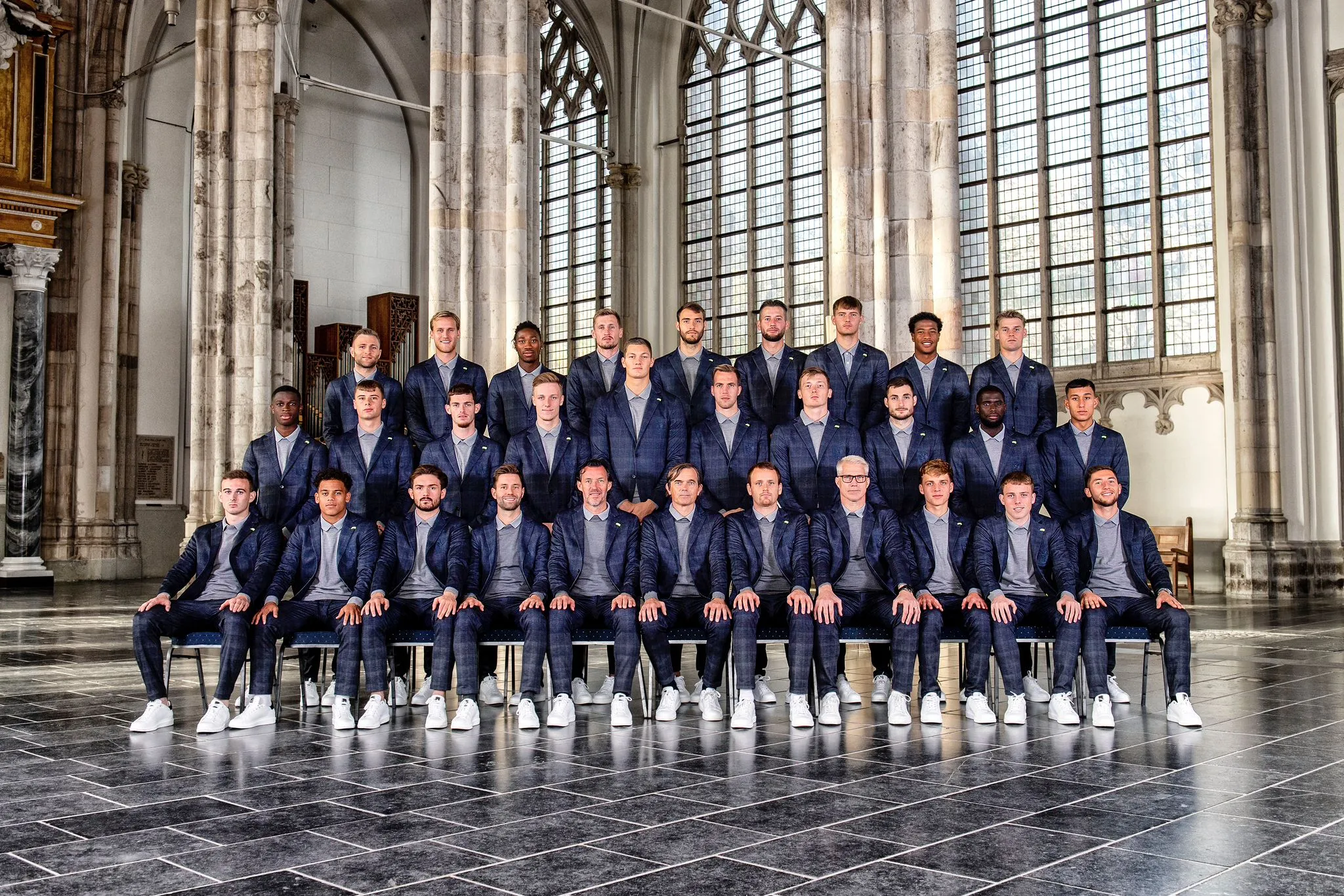 Voetbalteam Vitesse poserend in pakken in een kerk in Arnhem